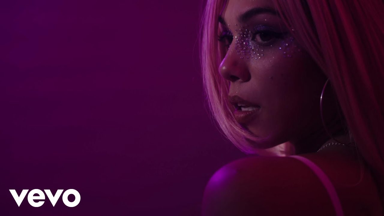 Playing Pretend music video: Bella Valdes on a corded phone in a pink bedroom.