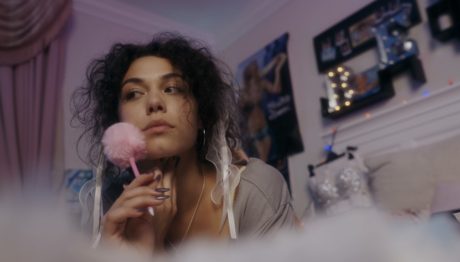 Playing Pretend still: Bella in her bedroom holding a pom-pom pen.